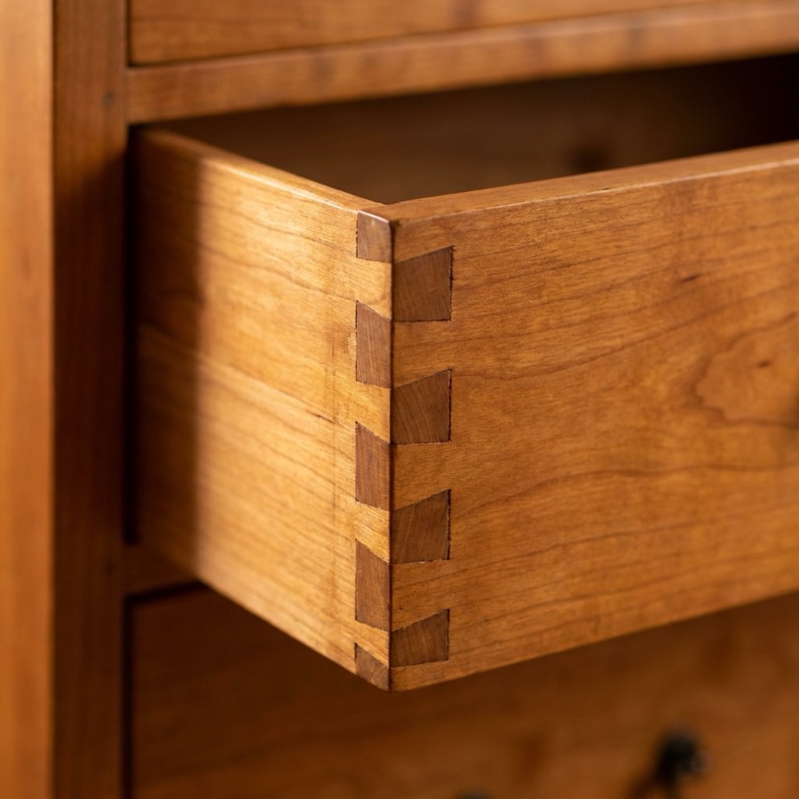 Detail of a dovetailed drawer box in cherry